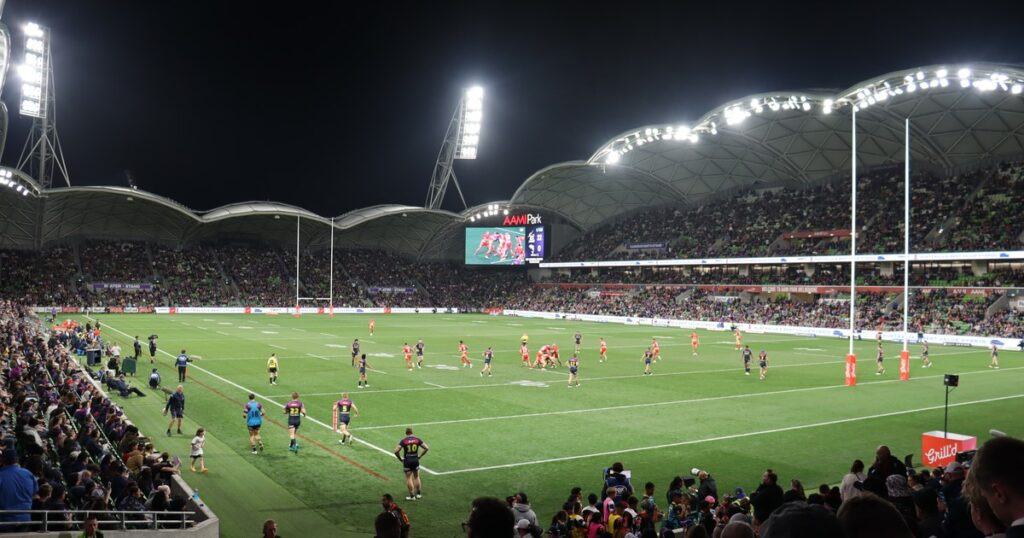 The Dolphins in action under lights in an NRL match against the Melbourne Storm