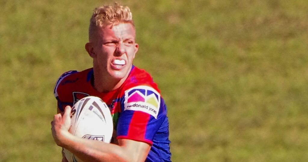 Phoenix Crossland in a Newcastle Knights jersey running with the ball