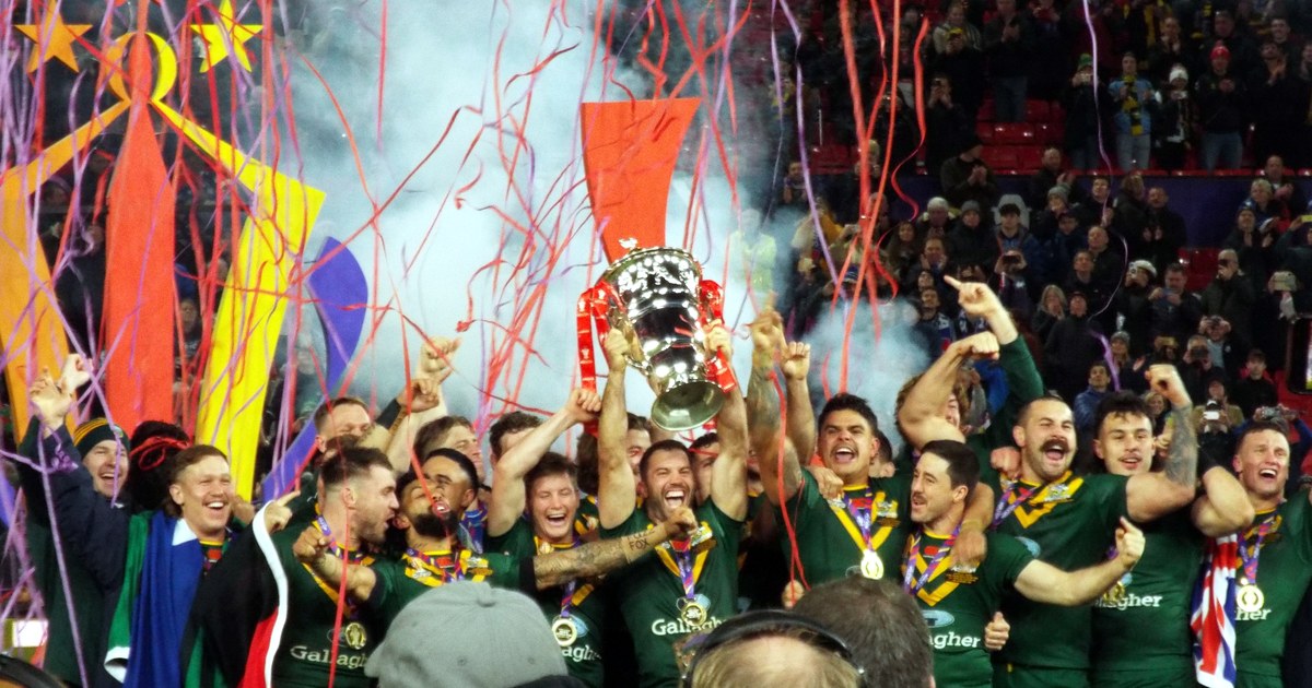 Australia's players lift the Rugby League World Cup trophy amid ticker tape