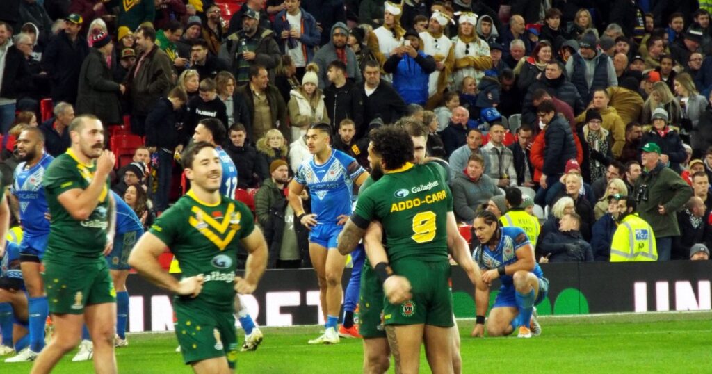 Australia and Samoa players on the field after the 2021 Rugby League World Cup final