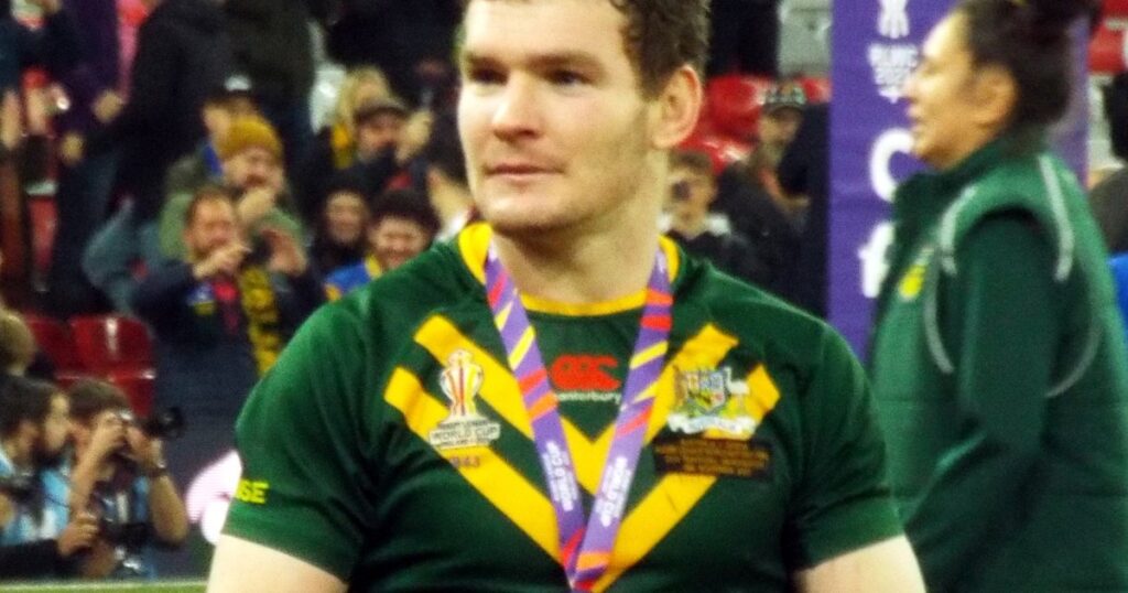 Liam Martin in a green and gold Australia jersey with a medal around his neck