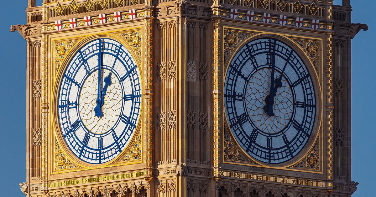 Two clock faces of Big Ben on the Elizabeth Tower in London against a blue sky