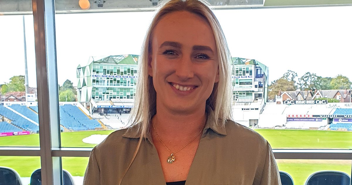 Jodie Cunningham smiling in a stadium box overlooking a rugby ground
