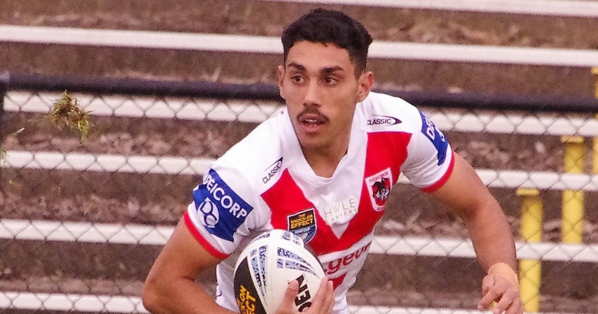 Tyrell Sloan running with the ball in a red and white St George Illawarra jersey
